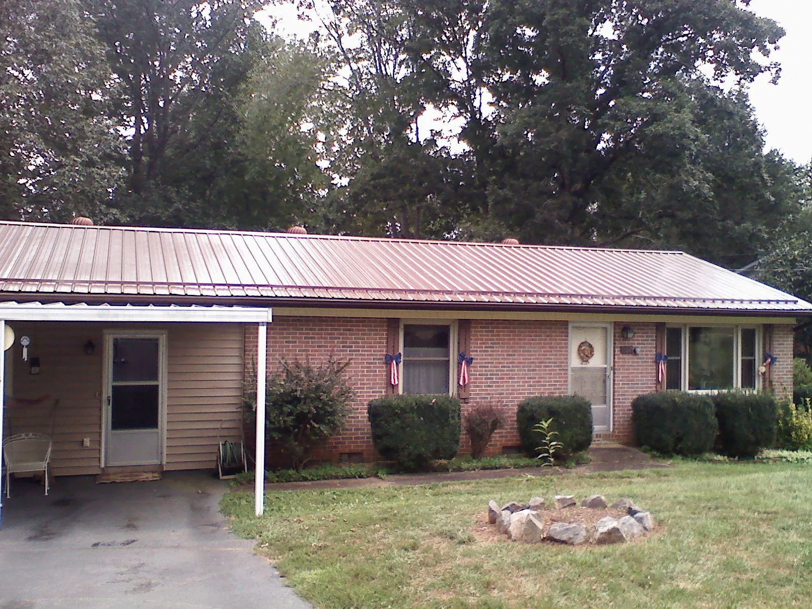 Bronze metal roof and carport on a brick ranch home — Roof Repair work by our crew in Cheshire
